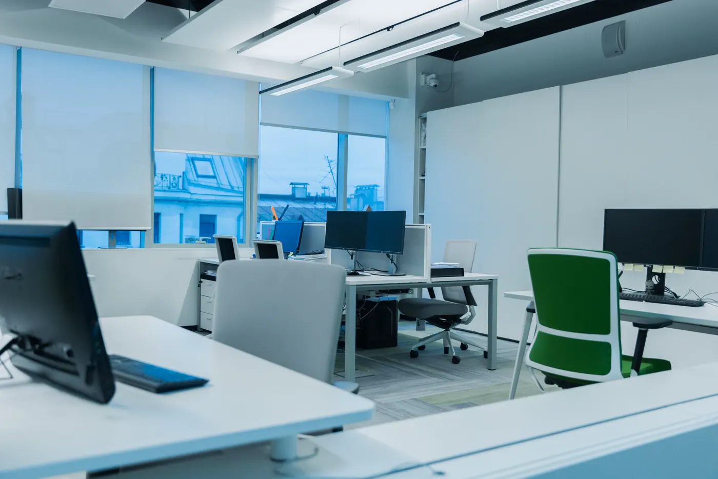A tidy modern office with workstations and natural light